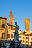 The Fountain of Neptune by Ammannati in the Piazza della Signoria in Florence, Italy. Behind are the campanile of the Badia Fiorentina and tower of the Palazzo del Bargello.