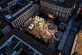 Aerial view of Christmas decoration and entertainment illuminated at night in El Pilar Square, Zaragoza, Spain