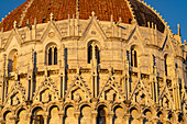 Detail of the Baptistery of St. John of the Pisa Cathedral in the Piazza dei Miracoli in Pisa, Italy. The top half of the baptistery is Gothic style, while the lower half is Romanesque.