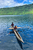 Residents of Vitu Islands in their traditional dugout canoes, Garove Island, Johann Albrecht Harbour, Papua New Guinea