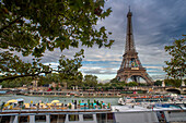 Passenger touristic cruise ship in the Seine river is moored to the pier near Eiffel Tower