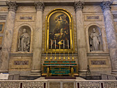 Altar and altarpiece of a chapel in the transept of the Basilica of St. Paul Outside the Walls, Rome, Italy. The altarpiece is flanked by statues of St. Gregory and St. Bernard.