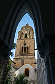 The campanile or bell tower seen through an arch of the cloisters of the Amalfi Duomo, Amalfi, Italy.