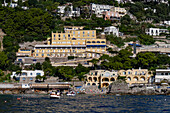 The seaside resort town of Marina Piccola by the Tyrrhenian Sea on the island of Capri, Italy. The large Hotel Weber Ambassador is at left.