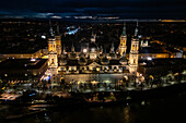 Aerial view of the Cathedral Basilica of Our Lady of the Pillar illuminated at night during Christmas, Zaragoza, Spain