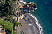 Tourists on the beach of the seaside resort town of Positano, Amalfi Coast, Italy.