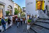 Tourists & shops on a street in the town of Capri, largest community on the island of Capri, Italy.