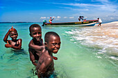 Children playing in the beach on Cayes-à-L’eau, a fishermen islet located northeast of Caye Grand Gosie, Île-à-Vache, Sud Province, Haiti