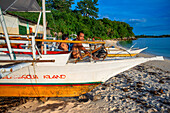 Local fishers in Guimbitayan beach next to white sand beach in Malapascua island, Cebu, Philippines