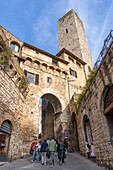 The Becci Arch and Becci Tower guard the entrance to the Piazza della Cisterna, San Gimignano, Italy.