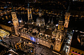 Aerial view of the Cathedral Basilica of of Our Lady of the Pillar and El Pilar square illuminated at night during Christmas, Zaragoza, Spain