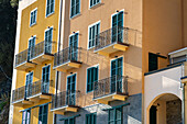 Balconies and shutters on colorful buildings in Monterosso al Mare, Cinque Terre, Italy.