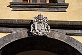 Papal crest or coat of arms of Pope Pius XI over the main portal of the Basilica of Sant'Antonino, Sorrento, Italy.