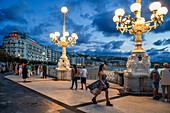 Street lamp at the seaside promenade at dusk, Playa de la Concha, Bahia de la Concha, San Sebastian, Donostia, Camino de la Costa, Camino del Norte, coastal route, Way of St. James, Camino de Santiago, pilgrims way, province of Guipuzcoa, Baskenland, Euskadi