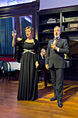 Singers performing during an opera dinner show in a restaurant in Rome, Italy.