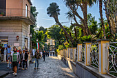 Tourists walking on the Via San Francesco in the historic center of Sorrento, Italy.