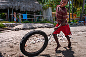 Local children playing in the plage de Ti Mouillage beach in Cayes-de-Jacmel, Cayes de Jacmel, Jacmel, Haiti.