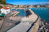 Picturesque houses, Fishing boats and sport fishing boats to recreational boat fishing are moored in the harbor of Donostia San Sebastian.