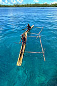 Residents of Tungelo Island in their traditional dugout canoes, New Ireland province, Papua New Guinea