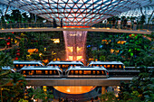 Jewel Changi Airport is a new terminal building under a glass dome, with indoor waterfall and tropical forest, shopping malls and dining, in Singapore