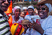 Haiti Voodoo Festival in Saut d'Eau, in Saut d'Eau, Ville Bonheur, Haiti. Thousands of both Vodou and Catholic followers gathered under the Saut d'Eau waterfall in Haiti. The pilgrimage, made by Voodou practitioners and Catholics alike, originated with the sighting of the likeness of the Virgin Mary on a palm leaf close to the falls half a century ago. Catholism and Voodou practices are forever intertwined in its Haitian form. The appearance of a rainbow beneath the falls is said indicate that Danbala - the great lord of the waterfall - and Ayida Wedo - the rainbow - are making love. Fertility