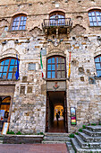 Facade of the 13th Century Palazzo Comunale, Palazzo del Popolo or city hall in San Gimignano, Italy.