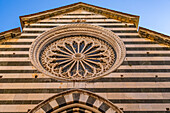 The rose window of the medieval Church of San Giovanni Battista in Monterosso al Mare, Cinque Terre, Italy. The facade is black and white marble.