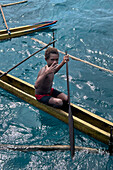 Residents of Tungelo Island in their traditional dugout canoes, New Ireland province, Papua New Guinea