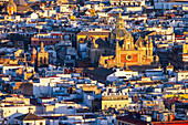 Explore the stunning aerial view of Iglesia del Salvador surrounded by city buildings in Seville, capturing the charm of Spain.