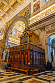 An ornate antique pipe organ in the transept of the Basilica of St. Paul Outside the Walls, Rome, Italy.