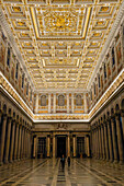 Two people in the central nave the Basilica of St. Paul Outside the Walls, Rome, Italy.