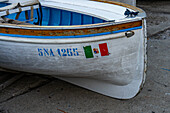 The Italian nautical flag on a rowboat hauled out in Marina Grande on the island of Capri, Italy.