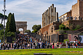 Roman columns along the Via Sacra and Arch of Titus in the Colosseum Archaeological Park in Rome, Italy.