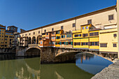 The Ponte Vecchio, a medieval stone arch bridge over the Arno in Florence, Italy.