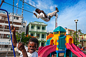 Chindren playing in the children's playground in Jacmel town square in Jacmel city center, Haiti