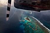 Maldives seaplane flying above islands