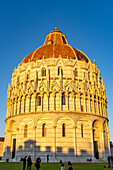 Baptistery of St. John of the Pisa Cathedral in the Piazza dei Miracoli in Pisa, Italy. The top half of the baptistery is Gothic style, while the lower half is Romanesque.