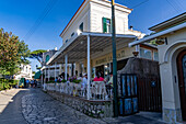 Diners at a restaurant on a street in Anacapri on the island of Capri, Italy.