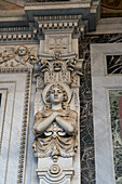 An angel carved on the door frame of the main portal of the Basilica of St. Paul Outside the Walls, Rome, Italy.