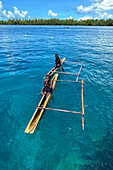 Residents of Tungelo Island in their traditional dugout canoes, New Ireland province, Papua New Guinea