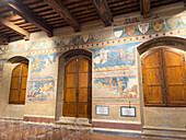 Medieval frescoes in the Sala di Dante of the 13th Century Palazzo Comunale or city hall in San Gimignano, Italy.