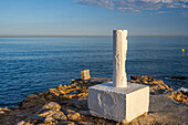 A geodesic marker at Torrecilla Beach in Nerja overlooking the Mediterranean Sea.