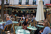 People sitting at Boheme cafe restaurant on a street avenue in Montparnasse Paris France EU Europe