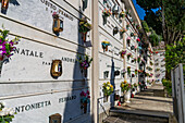 Flowers decorate the mausoleum niches in a cemetery in Anacapri on the island of Capri, Italy.