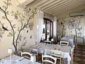 Painted walls of a restaurant in a farmhouse on a lavender farm in Taverna di Bibbiano, Siena, Italy.