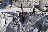 Hammer-driven steel wedges used to split marble blocks in a quarry. Fantiscritti Quarry Museum, Carrara, Italy.