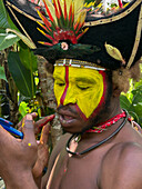 The Huli Wigmen of Papua New Guinea applying make up, Highlands Region