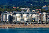 Landscape view over Playa de La Concha beach in San Sebastian, Gipuzkoa, Donostia San Sebastian city, north of Spain, Euskadi, Euskaerria, Spain. Hotel Londres (London) first building on right overlooking beach.