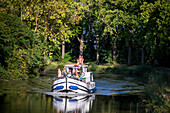 Nice landscape in the Canal du Midi near L'écluse de Marseillette South of France southern waterway waterways holidaymakers queue for a boat trip on the river, France, Europe