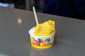 A cup of lemon sorbet and coconut gelato in Anacapri on the island of Capri, Italy.